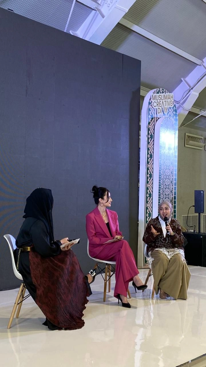 Muslimah Creative Day panel discussion on stage with three speakers